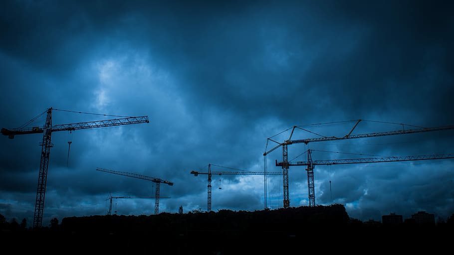 metal crane towers during cloudy day, silhouette of construction cranes under cloudy sky during daytime HD wallpaper