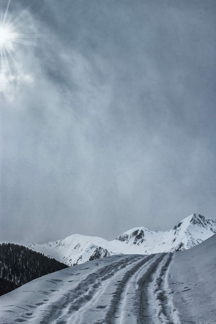 snow-covered mountain under cloudy sky during daytime, low-angle photography of white and gray mountain HD wallpaper