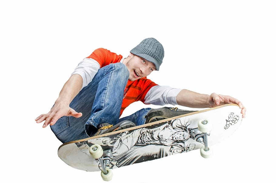 man in red and white shirt and blue jeans on white skateboard