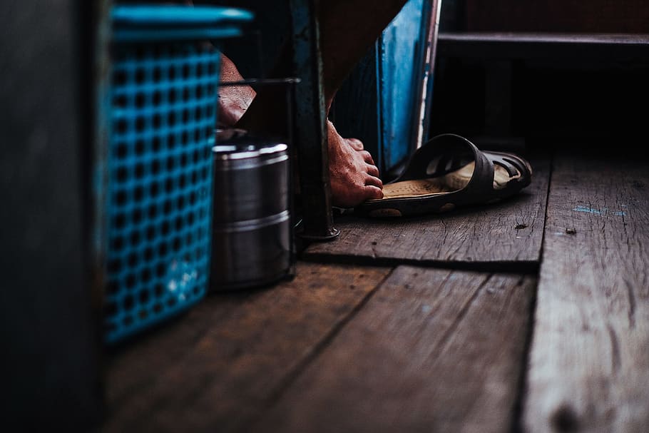 person reaching sandal with his foot, black slide sandal on floor HD wallpaper