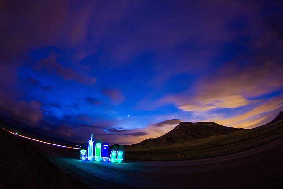blue and green building on desert, city light, dusk, sunset, landscape HD wallpaper