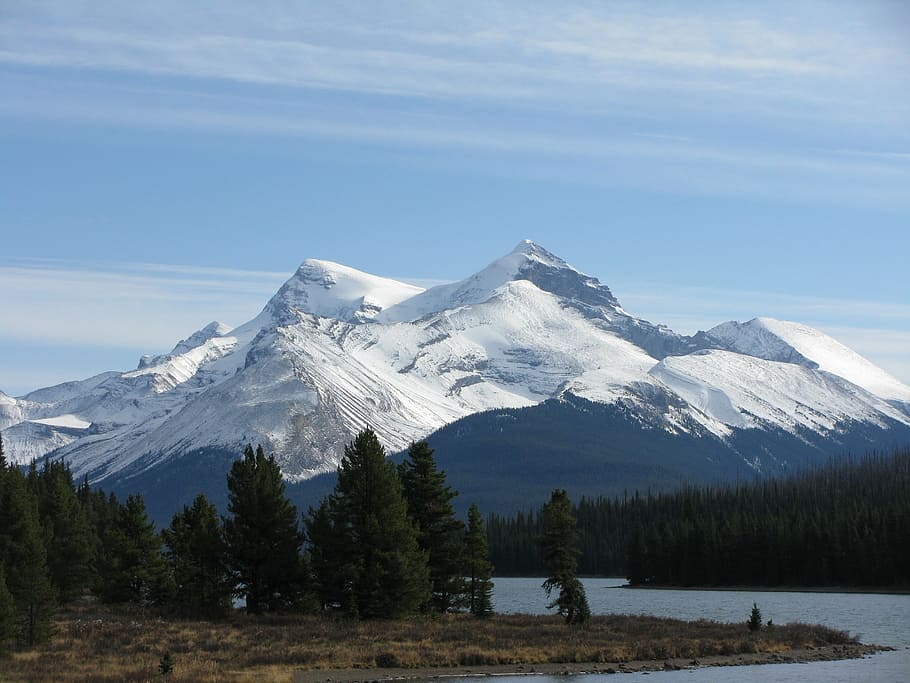 photo of mountain covered by snow under blue sky at daytime HD wallpaper