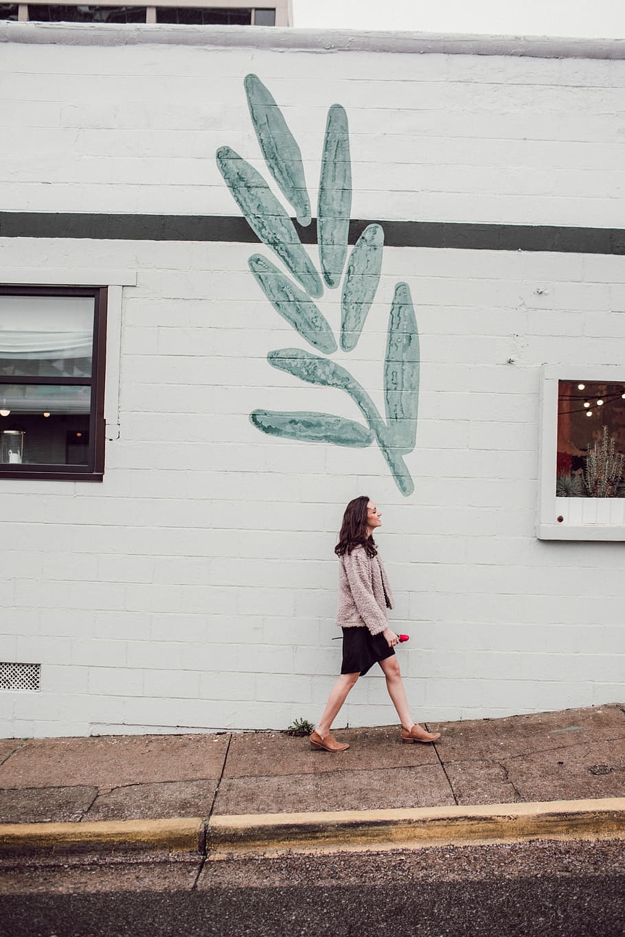 woman walking on pathwalk beside white concrete building, leaf HD wallpaper