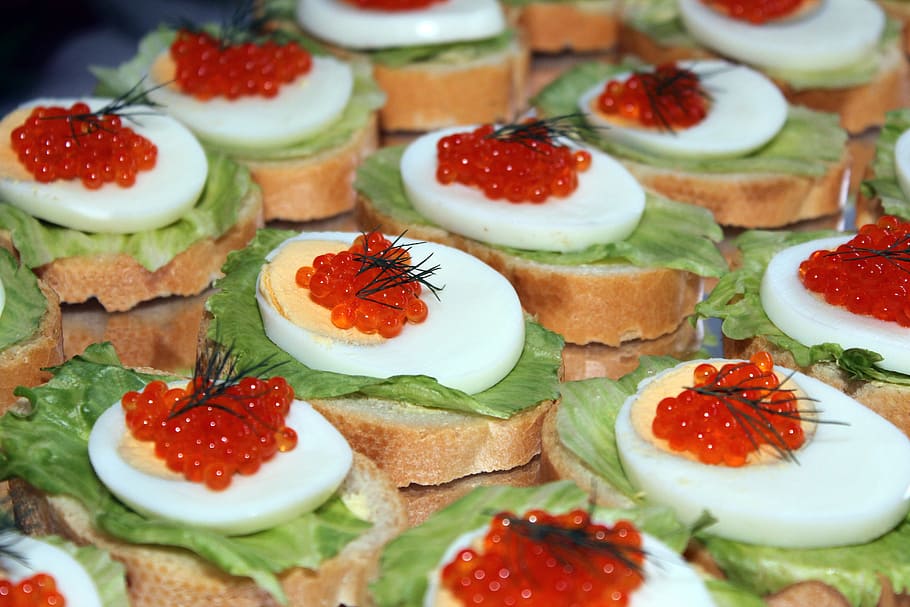 sliced sliced bread with hard boiled egg and caviar eggs toppings