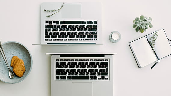 two silver laptop computers besides clear glass jar, two silver laptop computers beside of round gray plate with heart cookies HD wallpaper