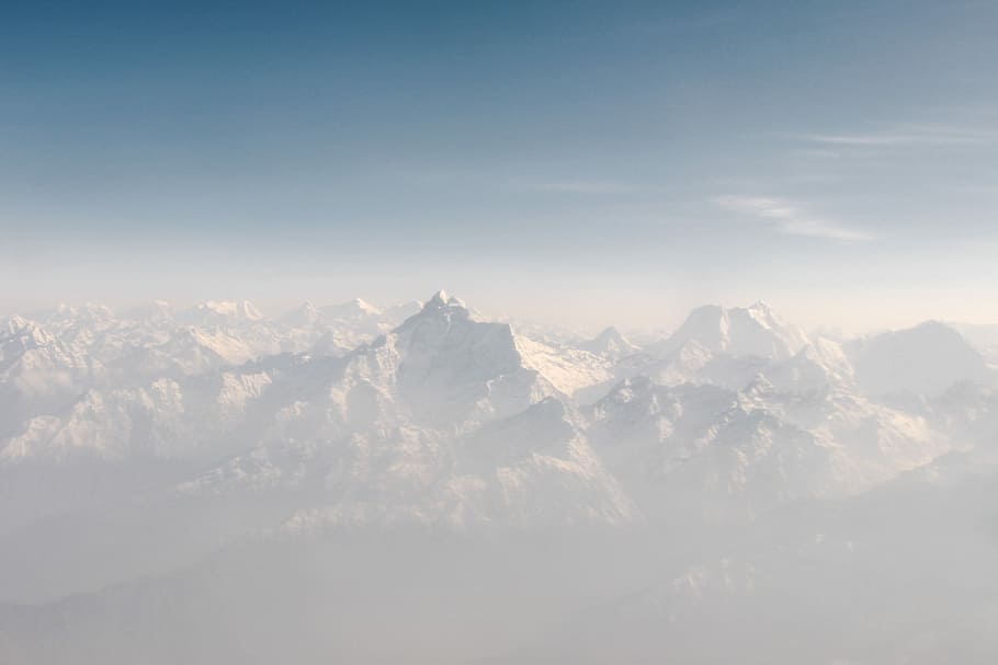 snow cap mountains under blue sky at daytime, snowy mountain covered with fog HD wallpaper