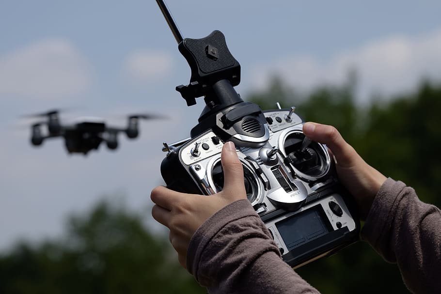 person holding quadcopter controller, drone, unmanned aerial vehicles, HD wallpaper