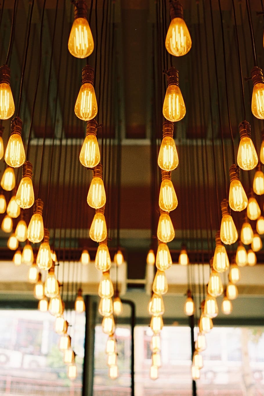 selective focus photography of light bulbs inside room, yellow hanging LED bulbs inside room with glass walls HD wallpaper
