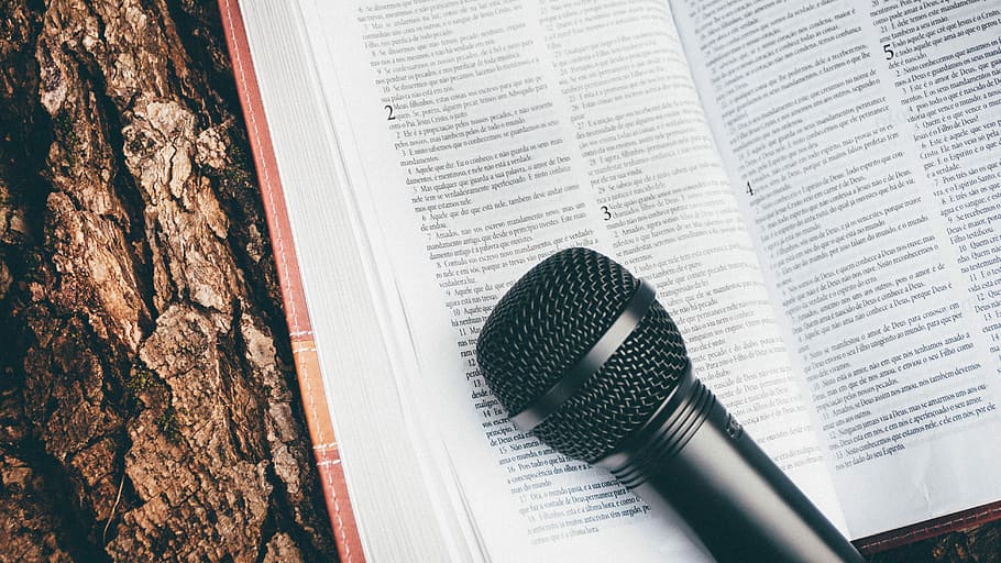 black microphone on book page, bible, open, technology, bark