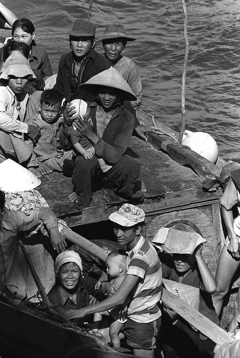group of people riding boat, boat people, 35 vietnamese refugees