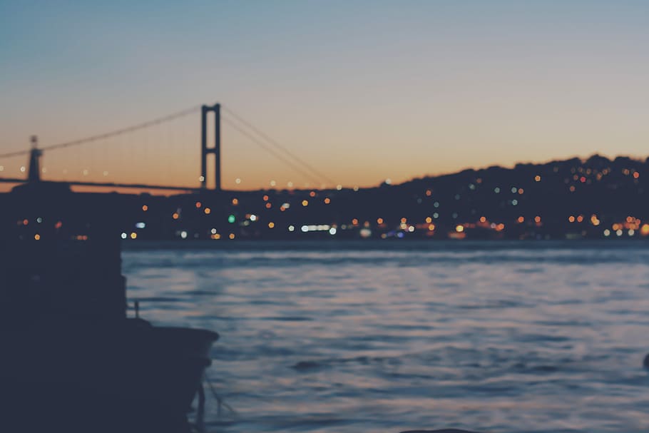 silhouette of fishing boat, body of water during night time, bridge HD wallpaper