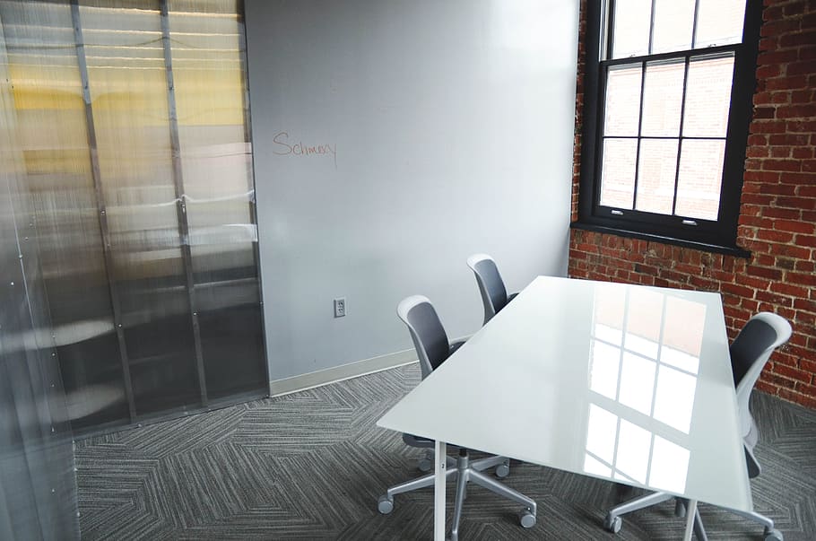 rectangular white wooden table with three vacant rolling chairs HD wallpaper