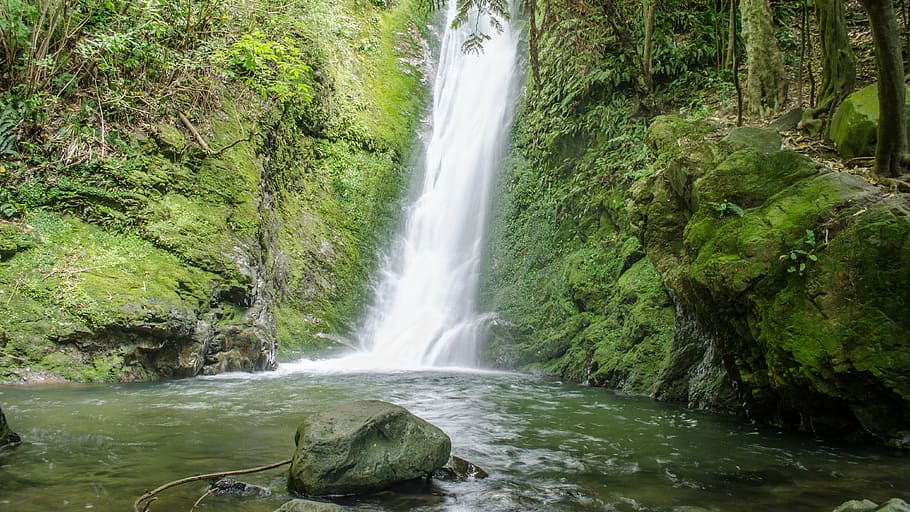 photo of falls in between rock formation covered of moss, waterfall HD wallpaper