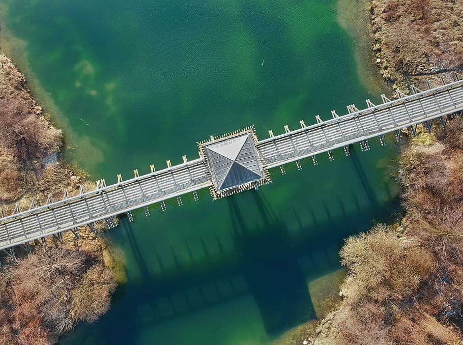 top angle photo of gray concrete bridge over green water taken at daytime, aerial photo of gray bridge during daytime HD wallpaper
