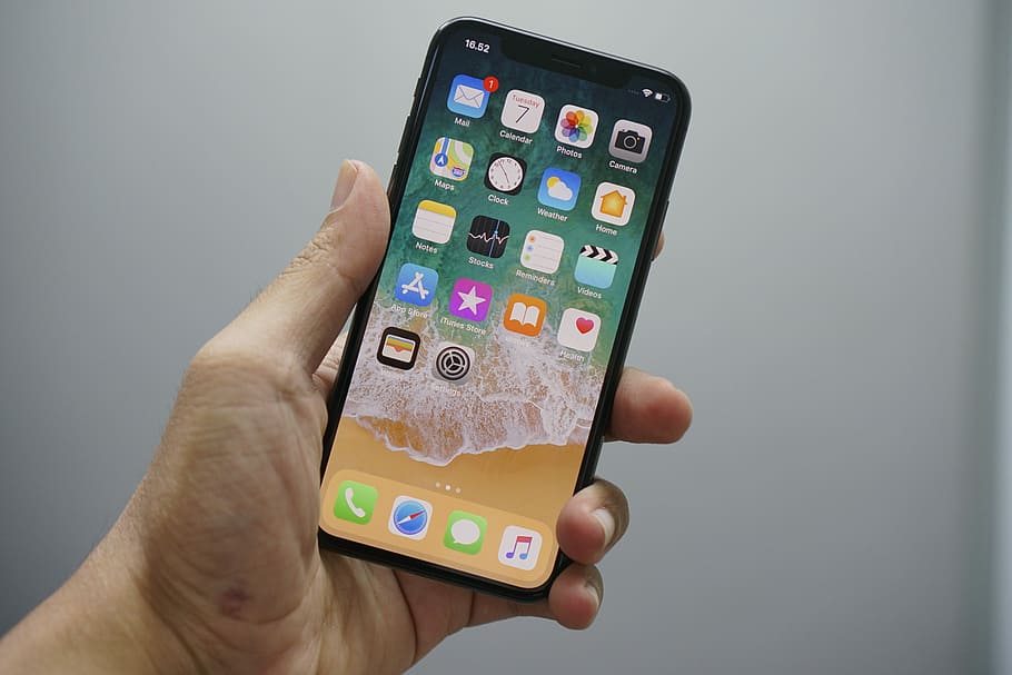 First time using iPhone X, person holding space gray iPhone X HD wallpaper