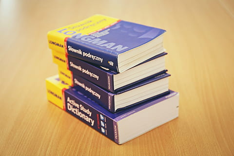 photo of four dictionary on table, blue, yellow, longman, books HD wallpaper