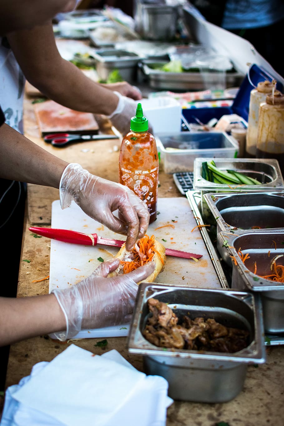 Vietnamese Banh Mi at food festival, baguette, hands, street food