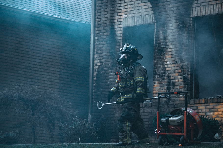 fireman holding rod near building at daytime, firefighter holding a shovel, HD wallpaper
