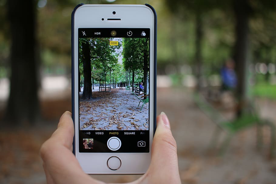person taking photo using silver iPhone 5s, person holding iPhone taking photo of sidewalk during daytime HD wallpaper