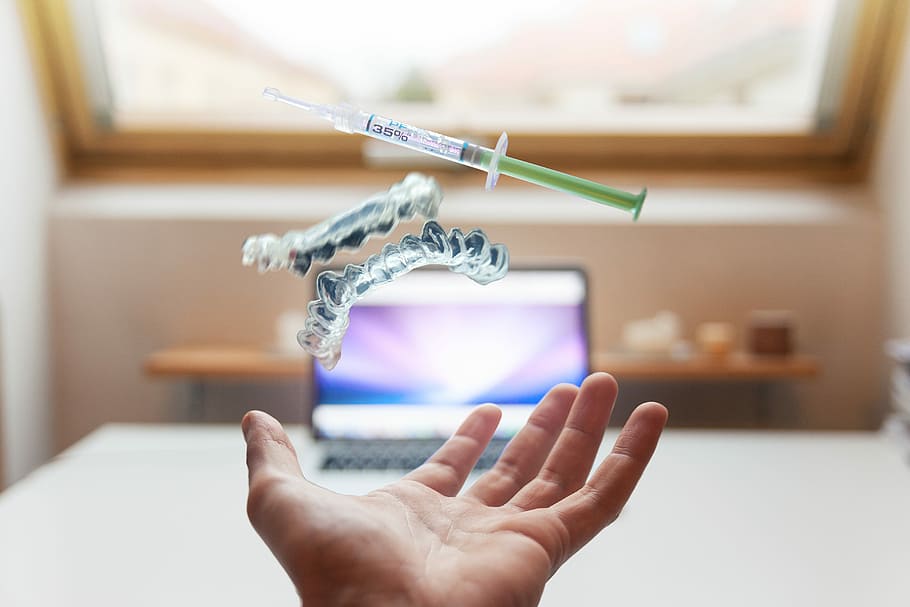 open palm with syringe floating above, person showing syringe HD wallpaper