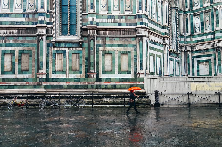 person holding umbrella walking on road, person using orange umbrella walking in the street HD wallpaper