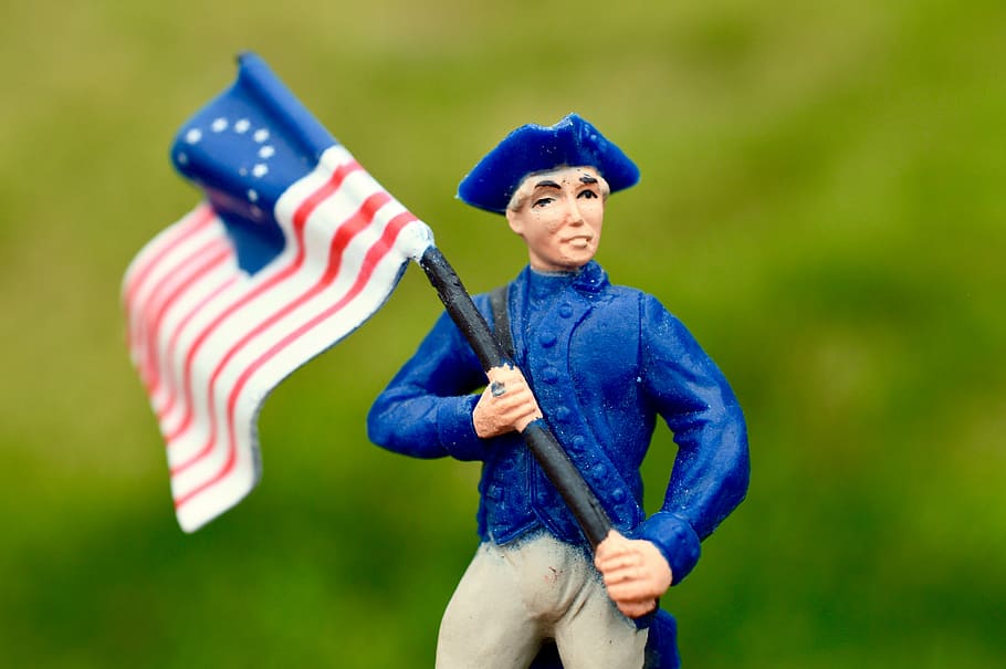 man holding United States of America flag figure, union soldier