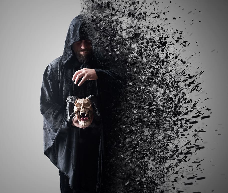 person wearing black suit while holding gray skull, spread HD wallpaper