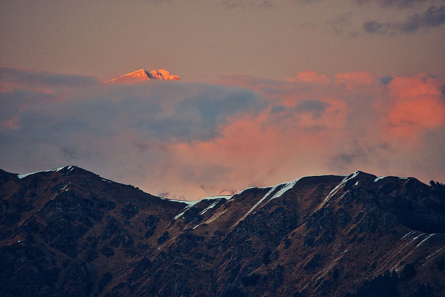bird's eye view of mountain peak over clouds, mountain covered by clouds HD wallpaper
