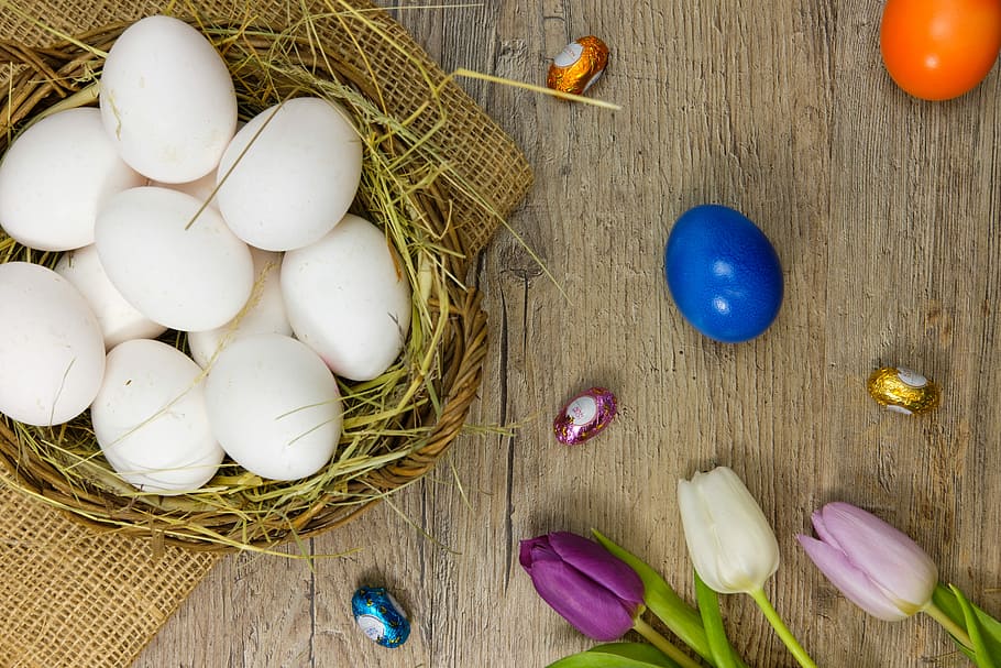basket of eggs near tulip flowers, easter eggs, colorful eggs HD wallpaper