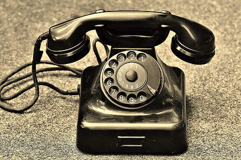 black rotary telephone on brown and black marble surface, old HD wallpaper
