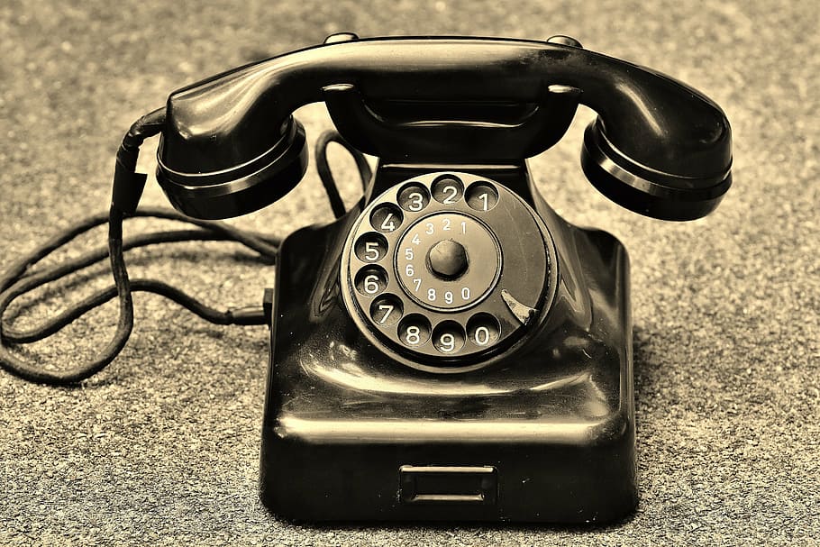 black rotary telephone on brown and black marble surface, old HD wallpaper