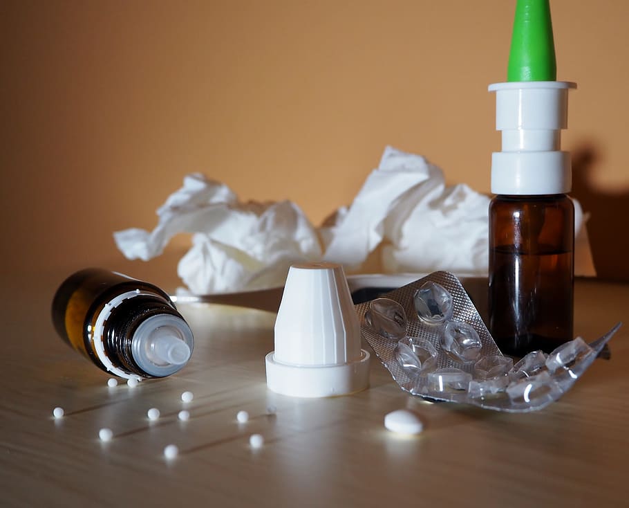 two brown labeled plastic bottles and empty blister pack on table HD wallpaper