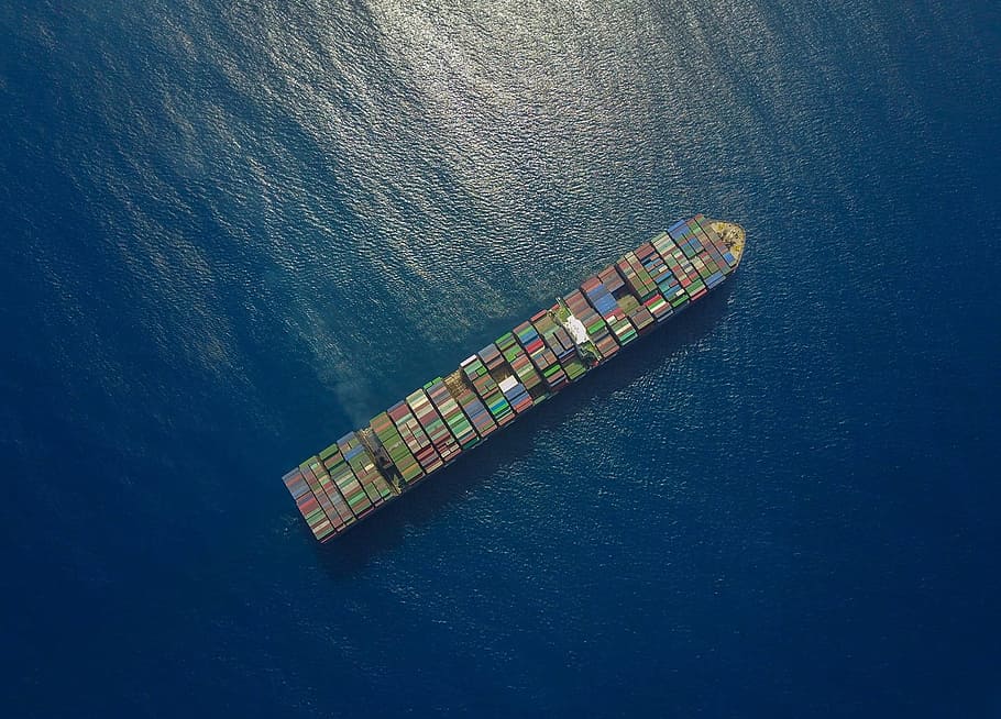 top view of ship loaded with shipping containers on sea during daytime
