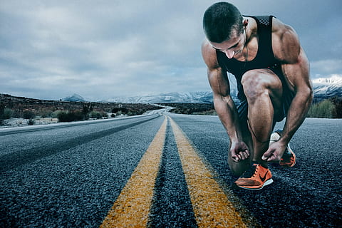 shallow focus photography of man in black tank top holding black shoe HD wallpaper