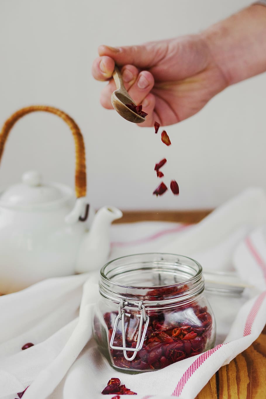 person holding brown spoon, teapots, jar, glass, table, table cloth HD wallpaper