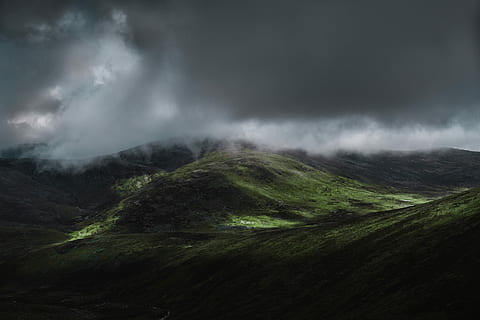 aerial view of green mountain under cloudy sky, landscape photography of hill under gloomy clouds HD wallpaper