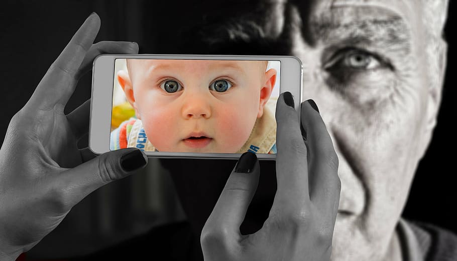 selective color photo of baby in beige top, smartphone, face HD wallpaper