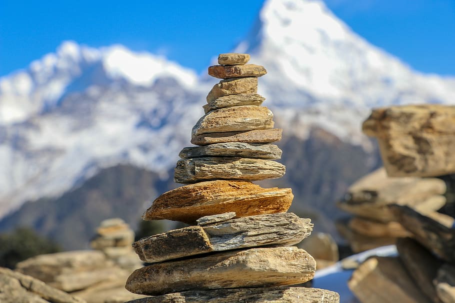 selective focus photo of stone stacking, brown stone stack outdoors HD wallpaper