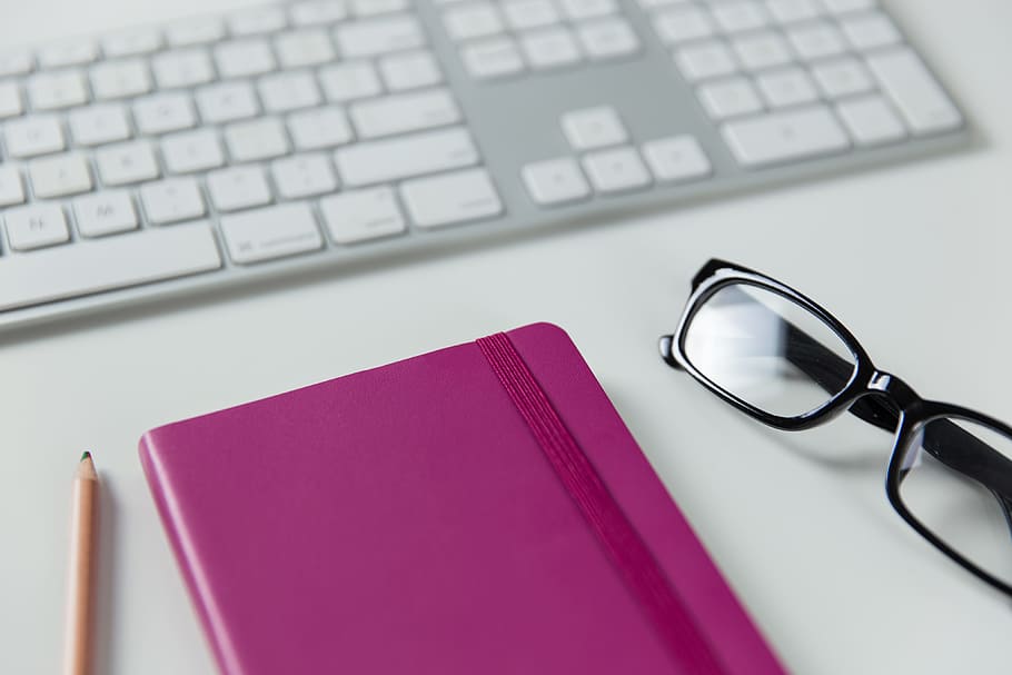 Computer keyboard, notepad and glasses on a white office desk HD wallpaper