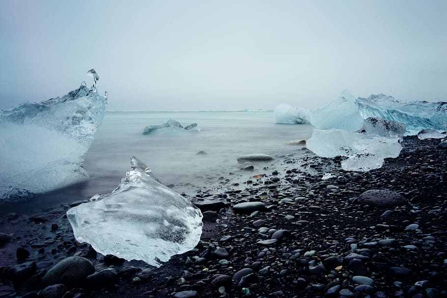 ice blocks on black stone fragment, ice blocks on seashore, burgs