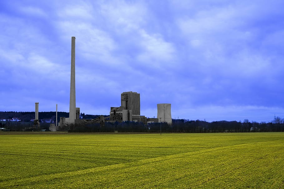 grass field with buildings at the distance, power plant, coal fired power plant