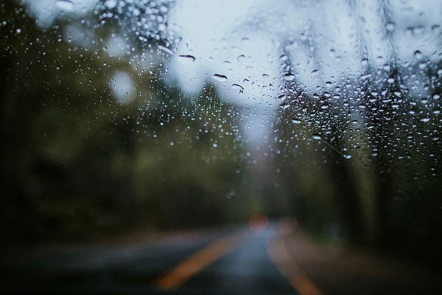 clear glass shrouded with droplets, winding road view through wet glass HD wallpaper