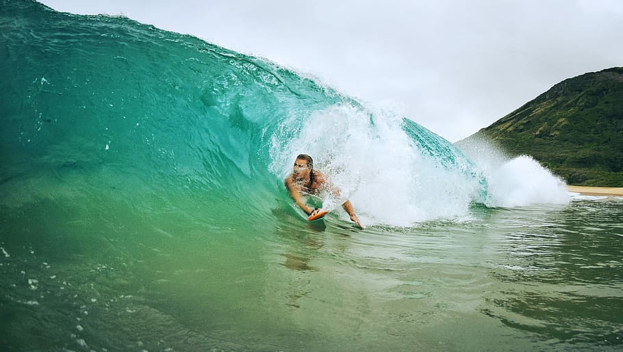 man surfing on waves during daytime, person on teal wave during daytime HD wallpaper