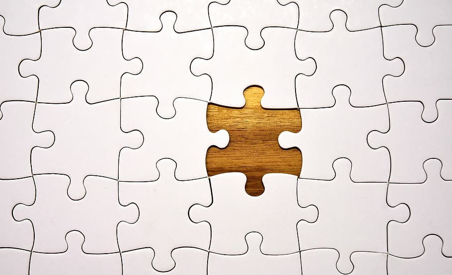 jigsaw puzzle with one piece missing on top of wooden surface