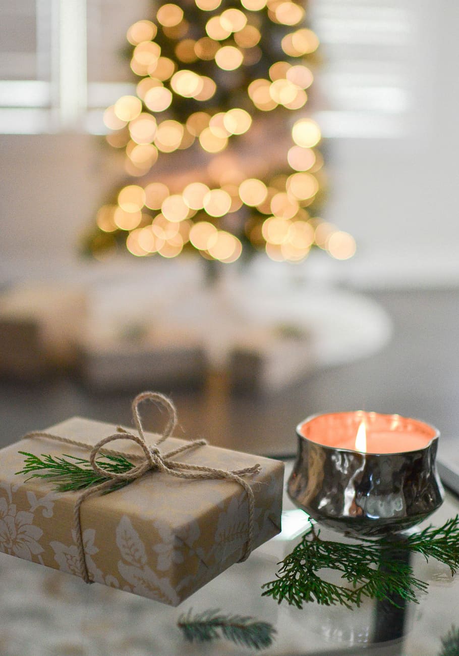 brown gift box beside stainless steel votive candle, present beside candle holder HD wallpaper