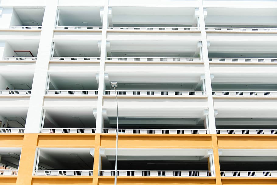 low angle photo of white and yellow concrete building, low-angle photography of white building HD wallpaper