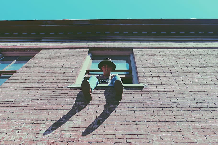 man sitting on window during daytime, men, people, outdoors, building Exterior HD wallpaper