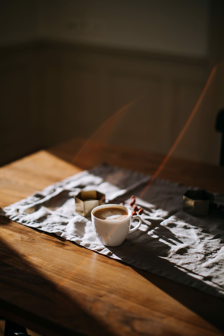 coffee mug on top of tablecloth beside ashtray, white ceramic mug on brown table HD wallpaper