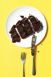 four slice chocolate cakes on plate beside fork and knife, white HD wallpaper