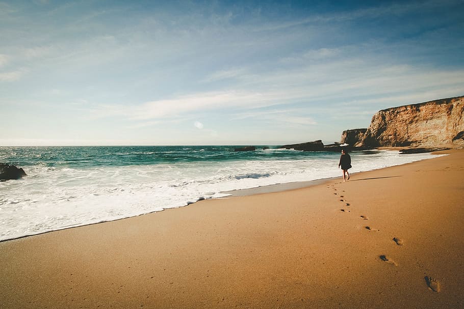 person walking along the seashore, beach, sand, ocean, footprints HD wallpaper
